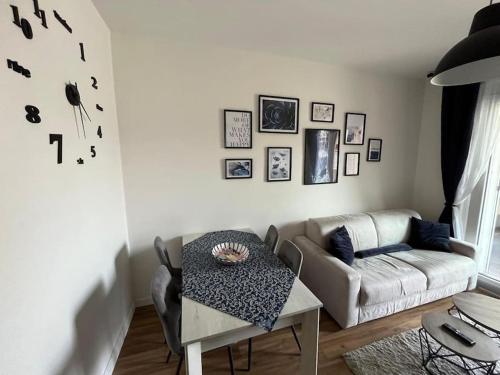 a living room with a table and a couch at New apartment close to the city center! in Milan