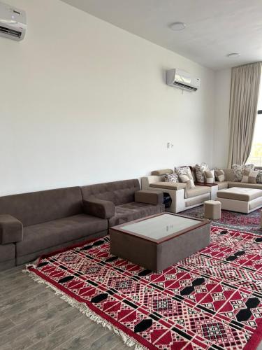 a living room with a couch and a rug at The Mountain Farm in Ras al Khaimah