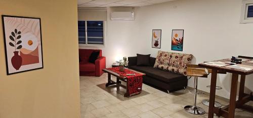 a living room with a couch and a table at Eclat Suites Hotel Boutique in Villa Mercedes