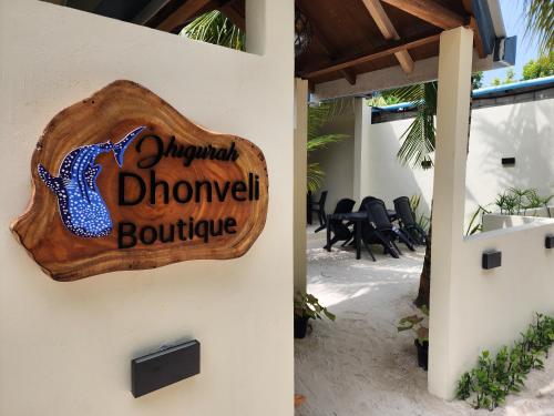 a sign on the side of a building that reads dinosaur downtown boutique at Dhigurah Dhonveli Boutique in Dhigurah