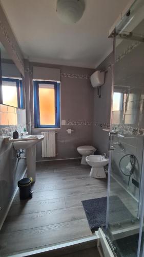 a bathroom with two toilets and a sink and a shower at Casa Mistral in Bari