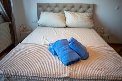 a blue towel sitting on top of a bed at Harmony Studio Apartment in Jagodina