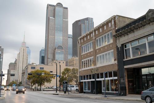 a city street with tall buildings in the background at SOVA Micro-Room & Social Hotel in Dallas