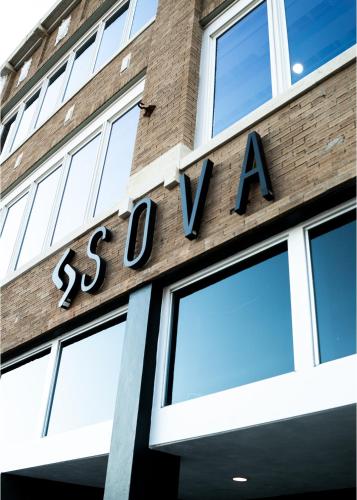 a store sign on the side of a building at SOVA Micro-Room & Social Hotel in Dallas