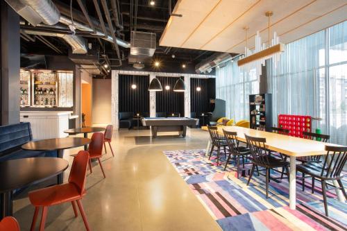 a restaurant with tables and chairs and a pool table at Aloft Omaha Aksarben Village in Omaha