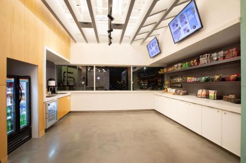 a large room with a grocery store with a cash register at Aloft Omaha Aksarben Village in Omaha