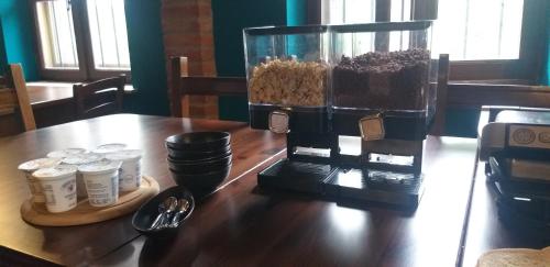 a table with a coffee maker on top of it at Mosci's Bed & Beer in San Damiano dʼAsti