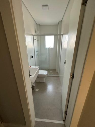 a bathroom with a toilet and a sink at Vista Panorâmica Enseada in Guarujá