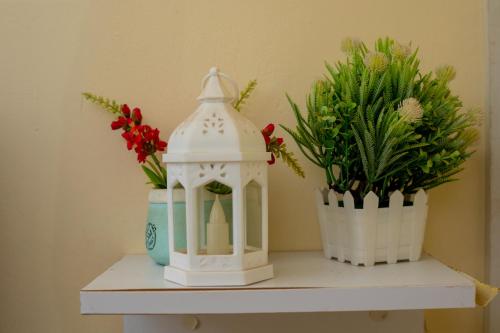 a white gazebo sitting on a shelf with flowers at Tom Mboya Estate - Fast WI-FI, Netflix and Parking 1Br Apartment in Kisumu Town in Kisumu