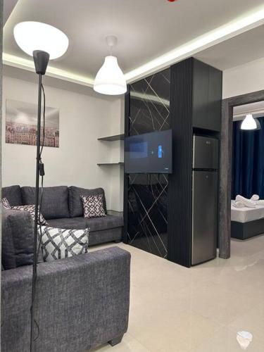 a living room with a couch and a tv at modern 2bedroom for rent abdoun2 in Amman