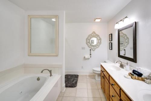 een witte badkamer met een bad, een wastafel en een toilet bij Hot Springs Duplex on Lake Hamilton with Shared Dock in Hot Springs
