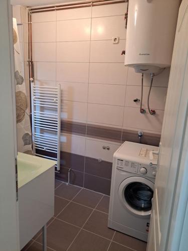 a small bathroom with a washing machine in it at Apartments Neyla in Sarajevo