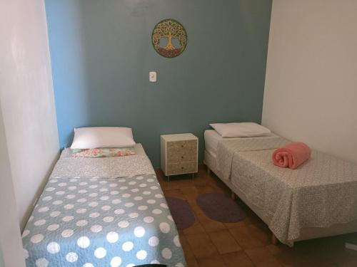 Pokój z dwoma łóżkami i zegarem na ścianie w obiekcie Varanda Hospedaria - SP Expo Hospedagem w São Paulo