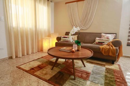 a living room with a couch and a coffee table at Casa Belcher in Cozumel