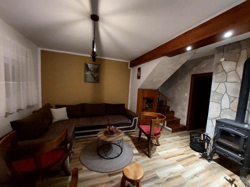 a living room with a couch and a fireplace at Vila Paramida in Šavnik