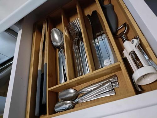a drawer with silver utensils in a cabinet at WEST Panorama Penthouse - apartment with a fantastic view of the city in Szombathely