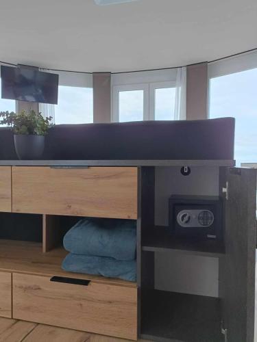 a desk with a tv on top of it at WEST Panorama Penthouse - apartment with a fantastic view of the city in Szombathely