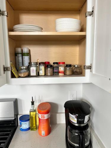 a kitchen cabinet filled with lots of dishes at NEW 4-bed 4-bath Stylish House with Mountain View and 2 garages in Lehi