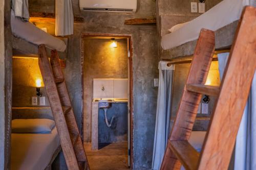 a small room with two bunk beds and a hallway at LaTaperaJeri Hostel in Jericoacoara