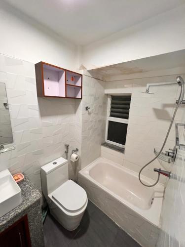 a bathroom with a toilet and a tub and a sink at Your home in Kathmandu! in Kathmandu