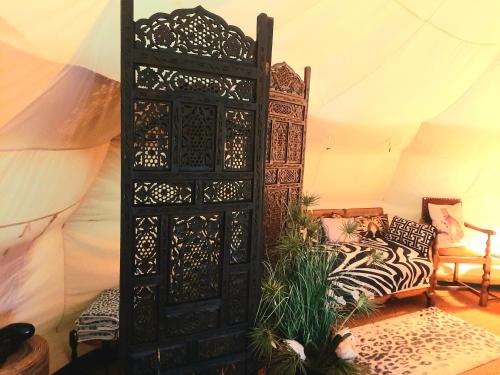 a room with a bed and a wooden door at Wild Retreat in Cawston