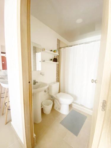 a bathroom with a toilet and a sink at Oasis Punta Cana Apartments 3 in Punta Cana