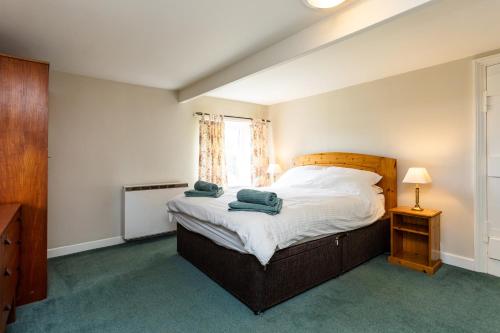 a bedroom with a bed with two towels on it at Bilton Farm Cottage No2 in Alnmouth