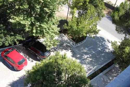 an overhead view of a red car parked in a parking lot at Hotel Mondo in Gjirokastër