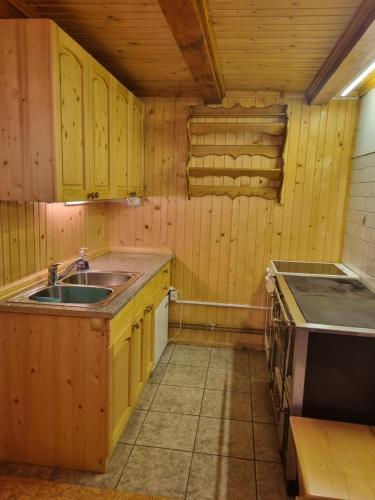 a small kitchen with a sink and a stove at BRINA Pokljuka in Zgornje Gorje