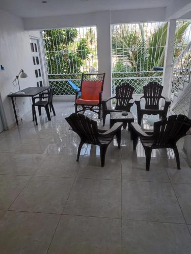 a group of chairs and tables on a patio at Samana house in Santa Bárbara de Samaná