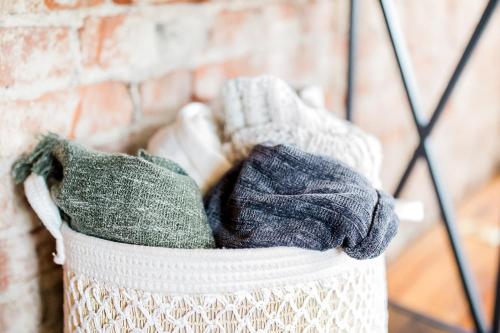 a basket filled with mitts in front of a brick wall at The Reserve - Heart of OTR 2 Bed Suite w/Views in Cincinnati