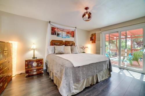 a bedroom with a bed and a sliding glass door at Pet-Friendly Reno Hideaway with Private Hot Tub! in Reno