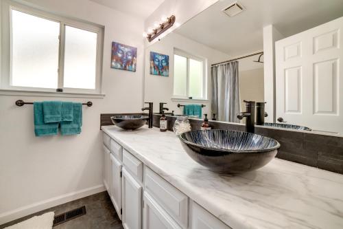 a bathroom with two sinks and a large mirror at Pet-Friendly Reno Hideaway with Private Hot Tub! in Reno