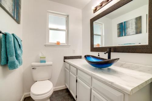 a bathroom with a sink and a toilet and a mirror at Pet-Friendly Reno Hideaway with Private Hot Tub! in Reno