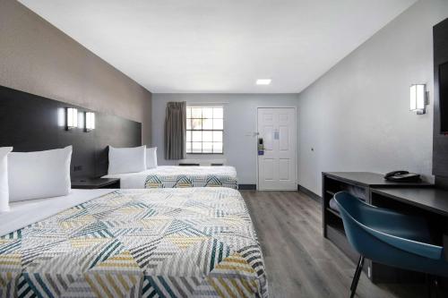 a hotel room with two beds and a desk at Motel 6-San Antonio, TX - Northwest Medical Center in San Antonio