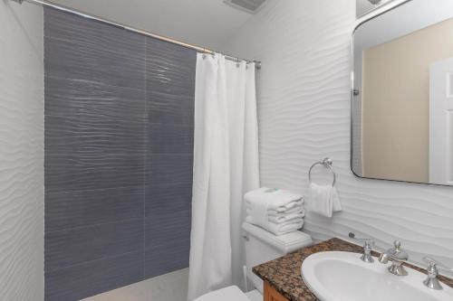 a bathroom with a shower and a toilet and a sink at Gulf Breeze Home/Remodeled 2Bdr in Gulf Breeze