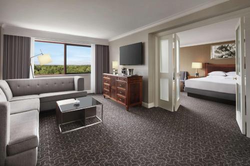 a hotel room with a couch and a bed at Hilton Short Hills in Short Hills