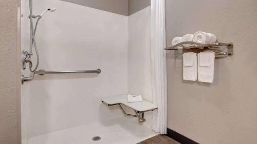 a bathroom with a shower and a toilet and towels at Studio 6 San Antonio TX Northwest Medical Center in San Antonio