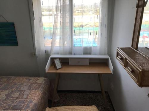 a room with a desk in front of a window at Oasis Near Barcelona Pool Tennis Beach in Sant Andreu de Llavaneres