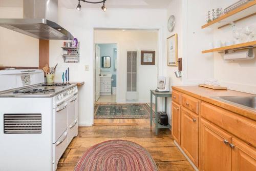 a kitchen with a white stove and a sink at Downtown Digs-Sauna, Hot Tub, Bikes - Fun Times! in Arcata