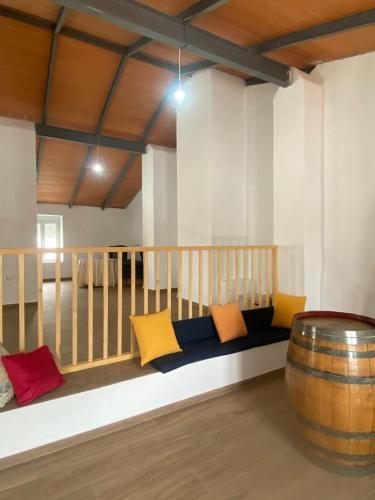 a couch in a room with a barrel at Casa Rural El Nini in La Coronada