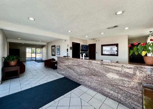 a lobby with a large marble counter in the middle at EZ Travel Inn College Station in College Station