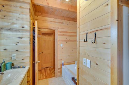 a log cabin bathroom with a tub and a sink at Serene Valley Bend Cabin Rental 7 Private Acres! in Valley Bend