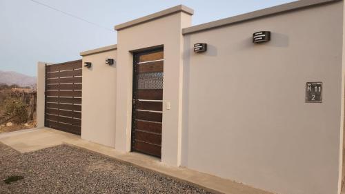 a pair of garage doors on a house at DEPARTAMENTOS CIELO DE CAFAYATE in Cafayate