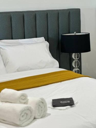 a bedroom with a bed with towels on it at Absolute Beachfront at the Pier Glenelg in Adelaide