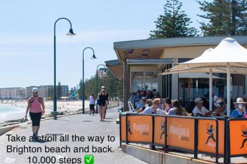 a group of people riding a train on the beach at Absolute Beachfront at the Pier Glenelg in Adelaide