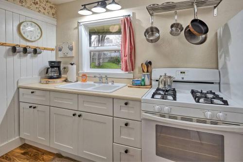 a white kitchen with a stove and a sink at Downtown Drift-Hot Tub,Sauna,Bikes,Pet Friendly in Arcata