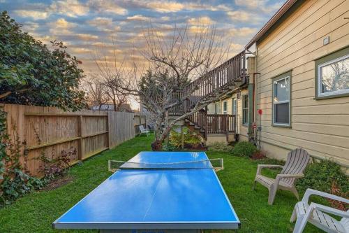 a blue ping pong table in the backyard of a house at Downtown Drift-Hot Tub,Sauna,Bikes,Pet Friendly in Arcata