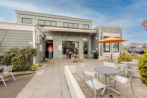 a patio with tables and chairs in front of a building at Downtown Drift-Hot Tub,Sauna,Bikes,Pet Friendly in Arcata