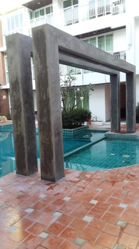 a metal structure next to a swimming pool at Arisara place in Koh Samui
